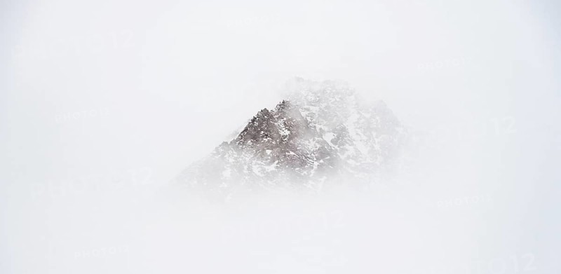 Mountains in winter with clouds and fog