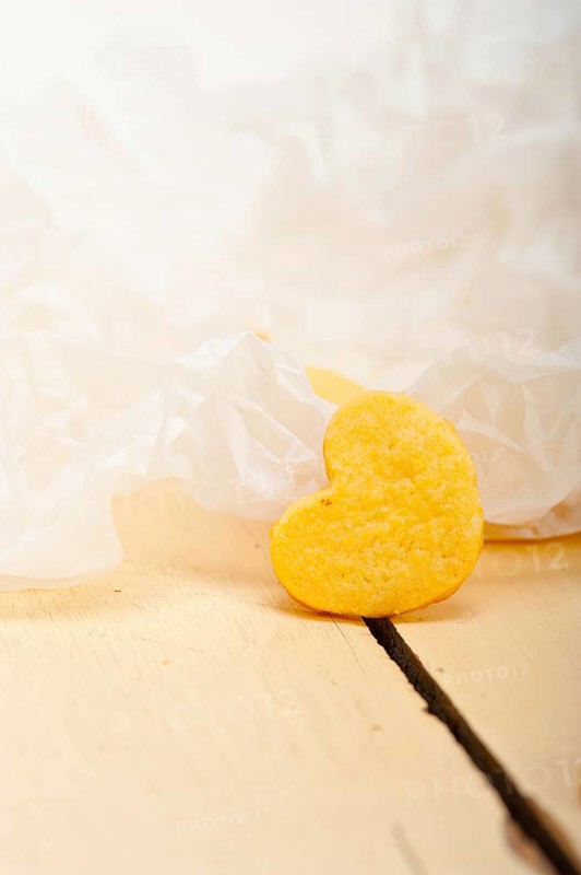 Fresh baked heart shaped shortbread valentine day cookies on a paper wrap