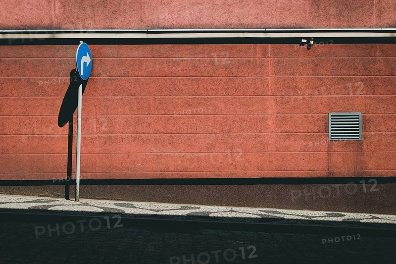 Empty street with blue road sign