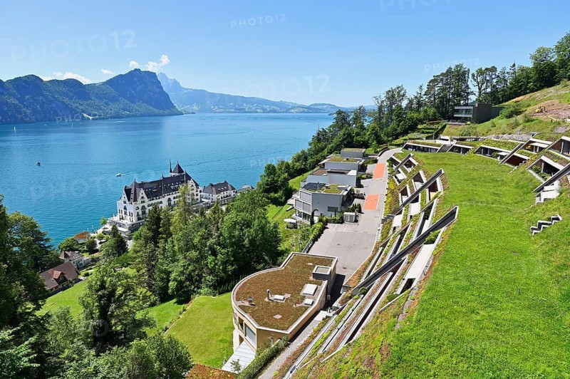 Modern earth houses built on a slope with a view of the Parkhotel and Lake Lucerne