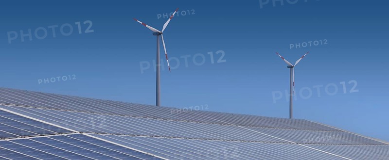 Solar plant with wind turbine in the background. Binsham