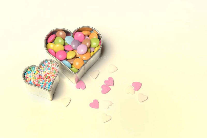 Chocolate lentils and love beads in heart-shaped cookie cutter