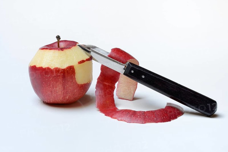 Peeled apple with peeling knife