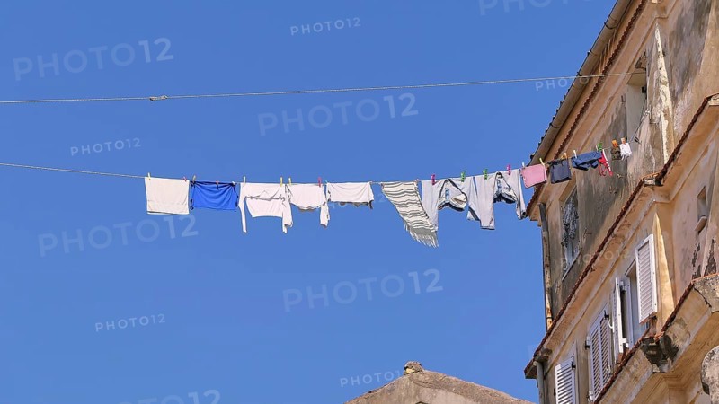 Clothesline with laundry hanging high above Old Town alley