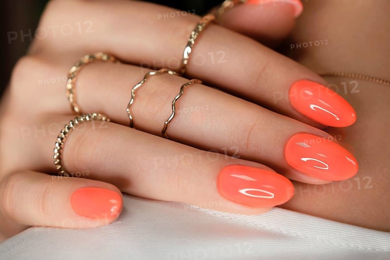 Bright neon manicure on female hands with accessories. Nail design. Beauty hands