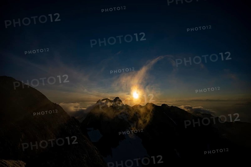 Altmann summit with yellow cloud wisps at sunrise