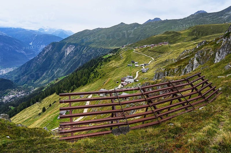 Metal avalanche barrier above the village