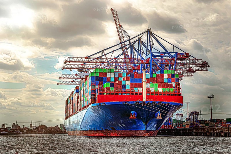 A container ship is loaded with many colourful sea containers in the port of Hamburg. Hamburg