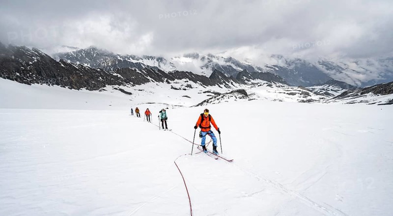 Ski tourers ascending the rope