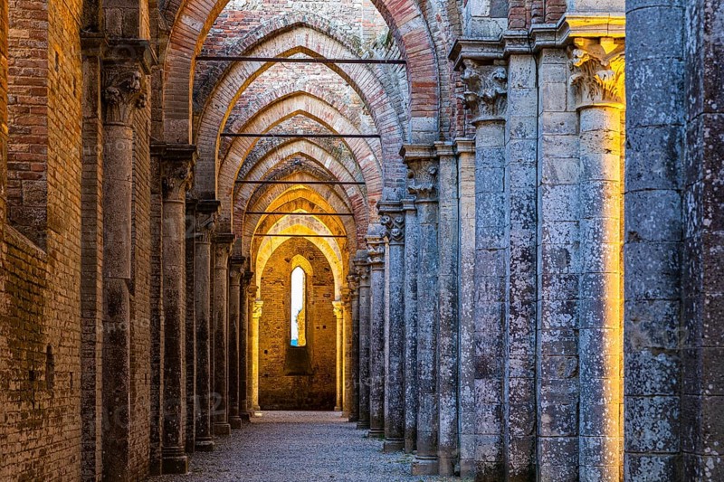 Side aisle of the ruined church of San Galgano Abbey in the evening light