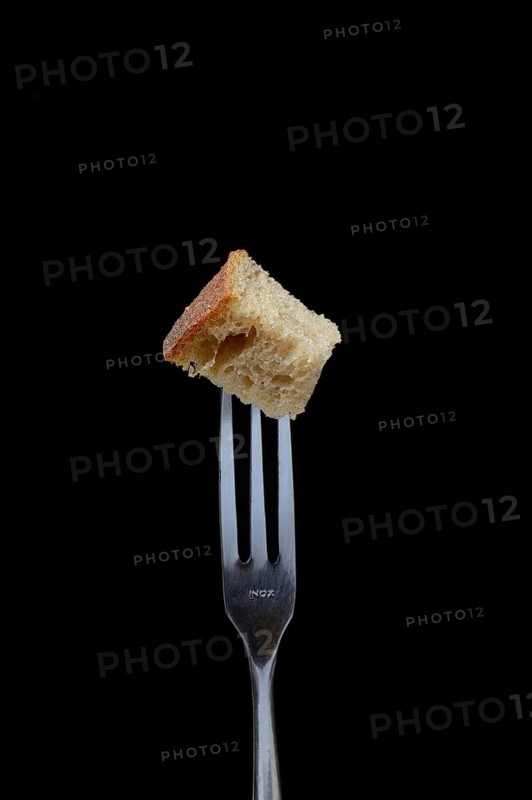 Bread cubes on fondue fork