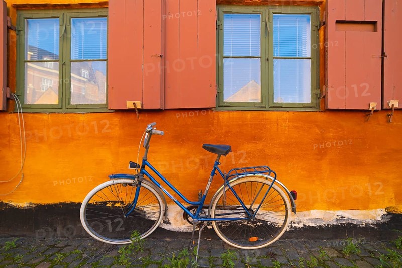 Bike leaning against the orange wall