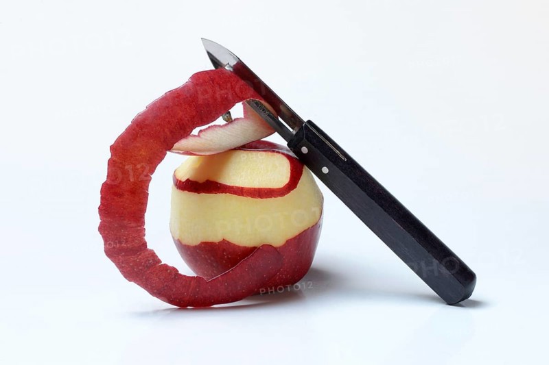 Peeled apple with peeling knife