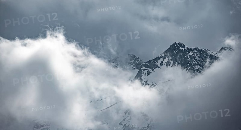 Mountains in winter with clouds and fog