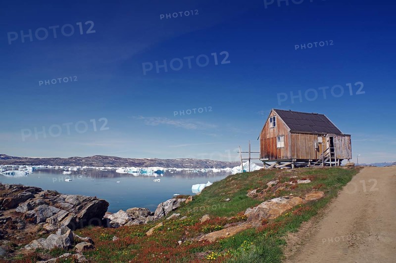 Simple cabin on a fjord