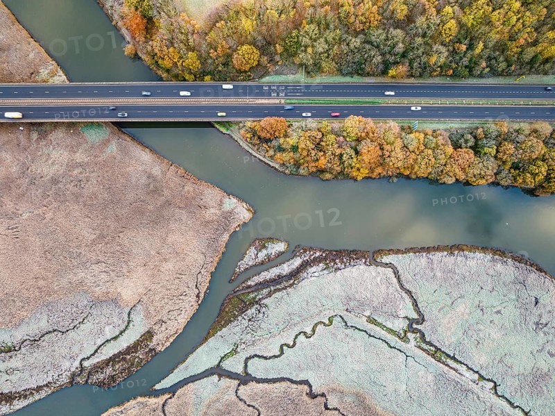 Top Down view over Marshland and Bridge of River Teign shrouded in frost at morning sun from a drone