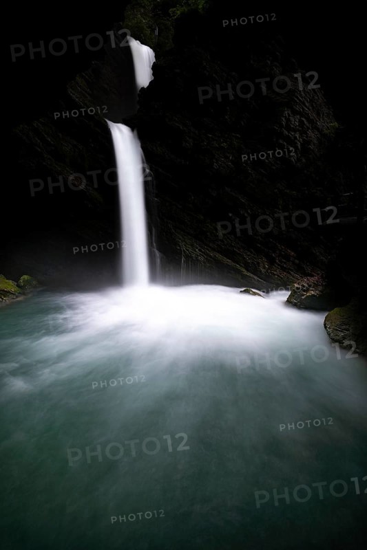Waterfall in dark gorge