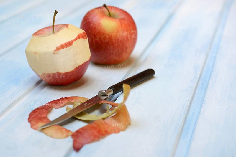 Peeled apple with peeling knife