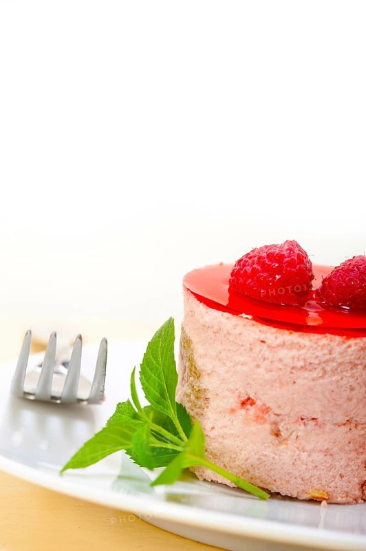 Fresh raspberry cake mousse dessert round shape with mint leaves