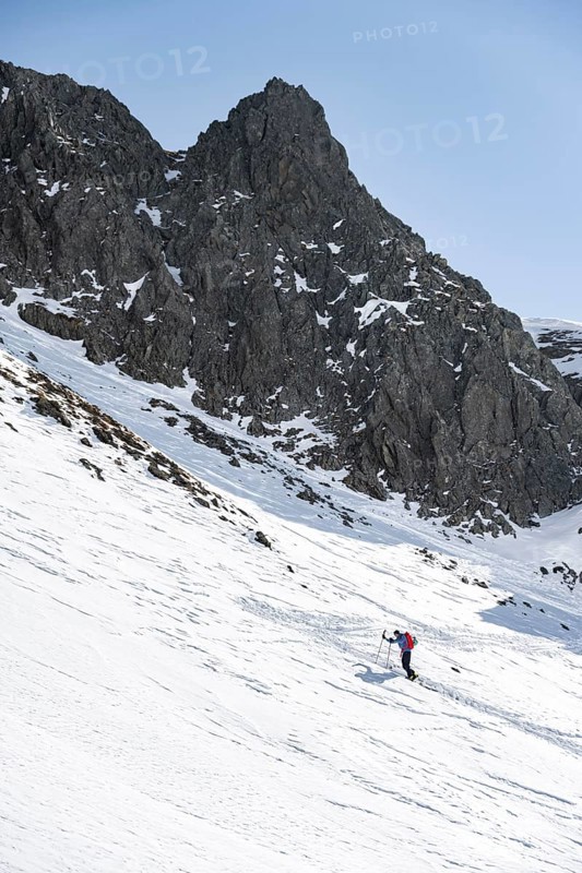 Ski tourers on the ascent in a saddle