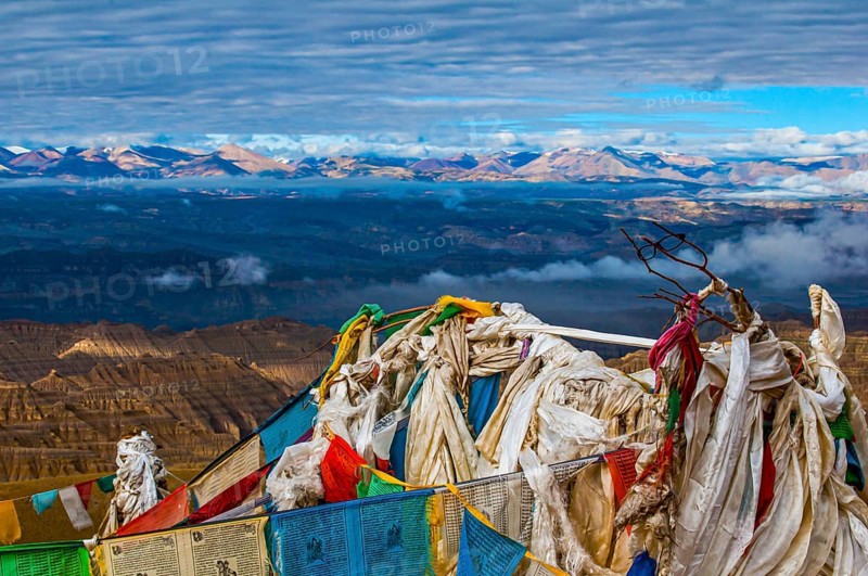 Prayer flags over the eroded mud landscape in the kingdom of Guge