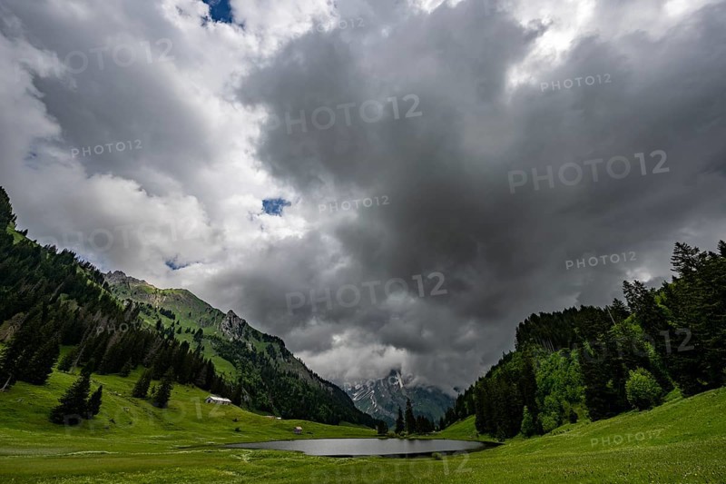 Groeppelensee with Altmanngipfel in the background under a threatening cloudy sky