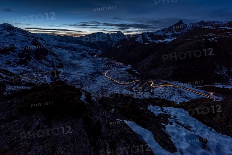 Night photograph with light traces of vehicles on the pass road of the Julier Pass