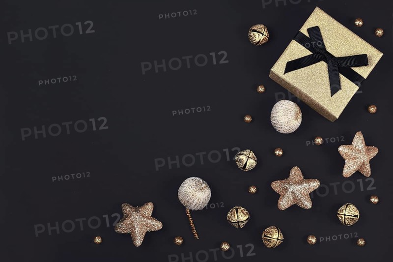 Christmas flat lay with golden gift box surrounded by shiny star