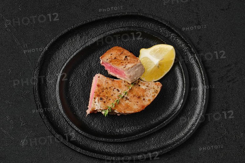 Top view of roasted tuna steak in a slate plate