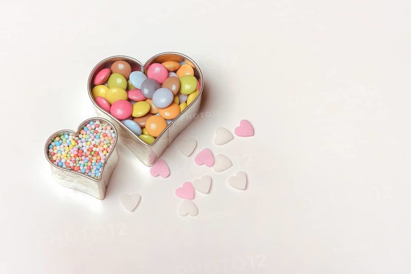 Chocolate lentils and love beads in heart-shaped cookie cutter
