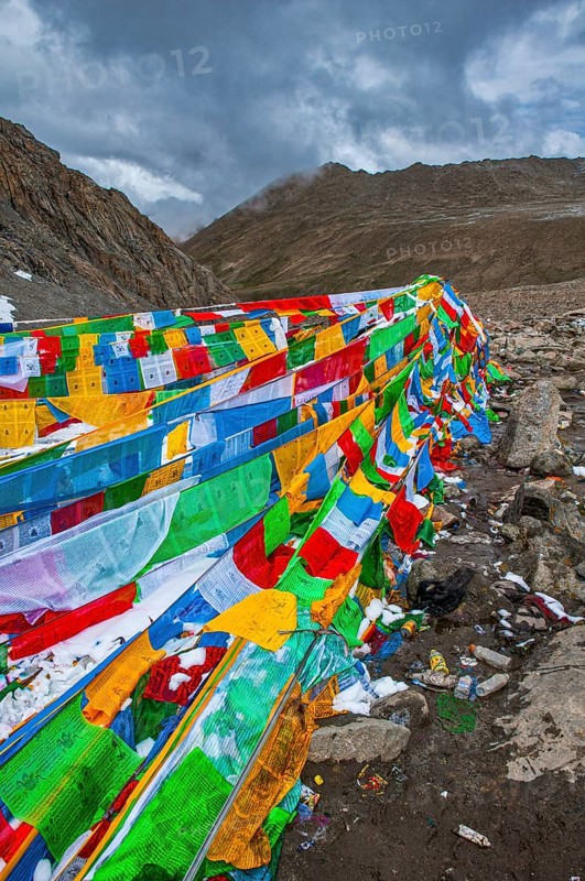 Praying flags and stones on a mountain pass