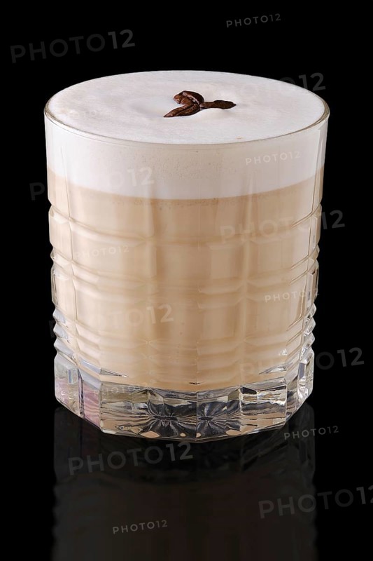 Cappuccino or latte with coffee syrup on black background with reflection