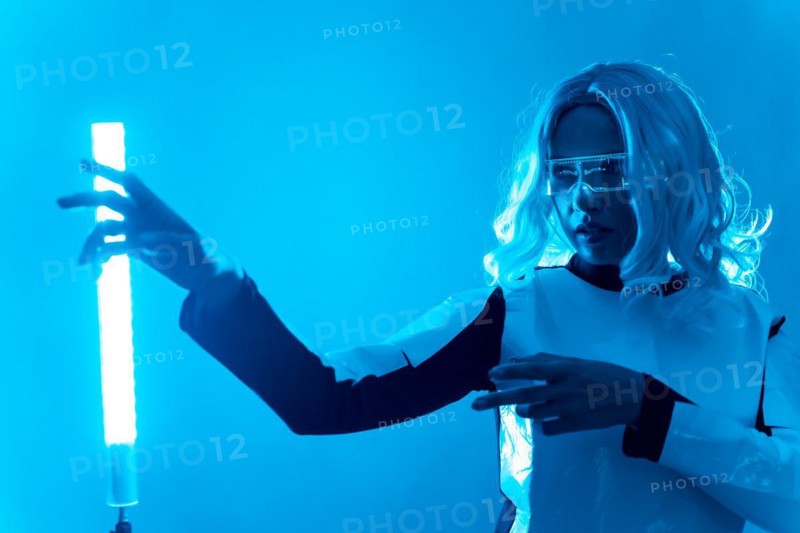 A woman in a futuristic suit and glasses with blue lights