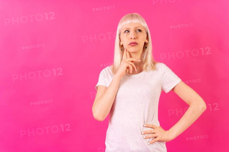 Blonde caucasian girl studio shot on pink background
