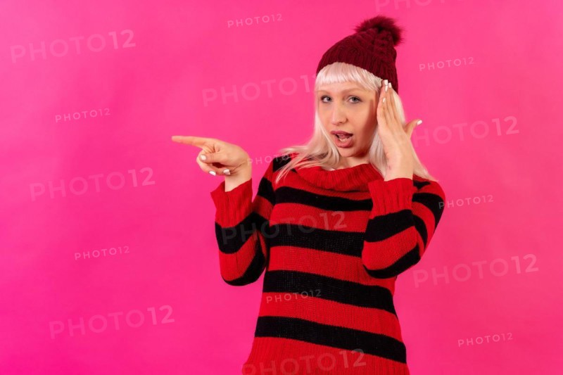 Blonde caucasian girl on pink background studio