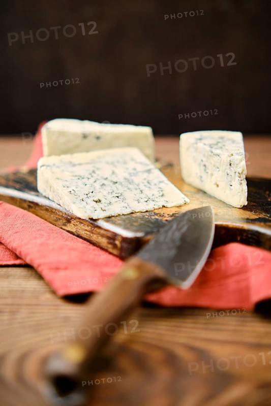 Photo with shallow depth of field of different types of blue cheese