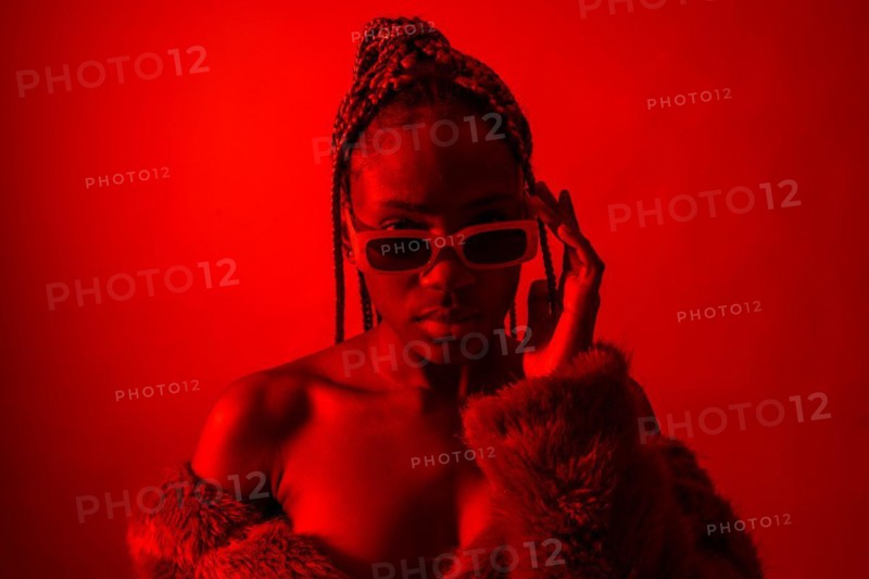 Attractive black ethnic woman with braids with red led lights