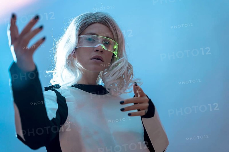Woman watching with the illuminated futuristic glasses