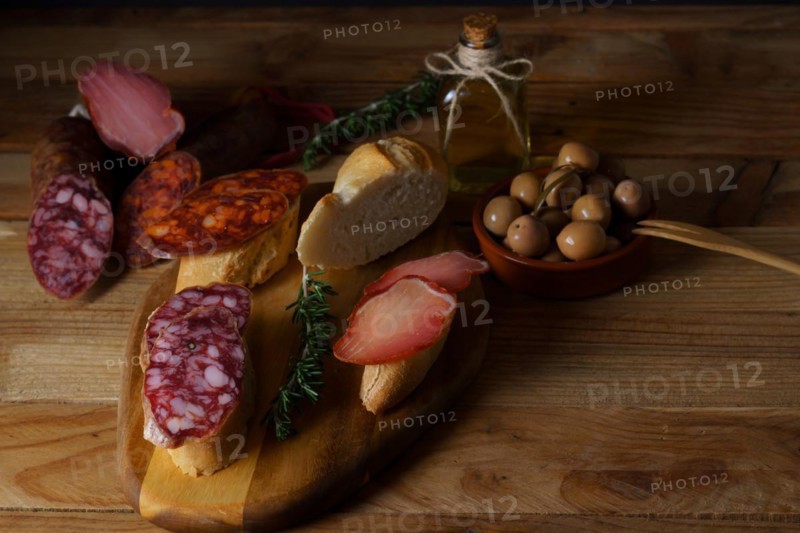 Top view of a wooden board with sausage. chorizo