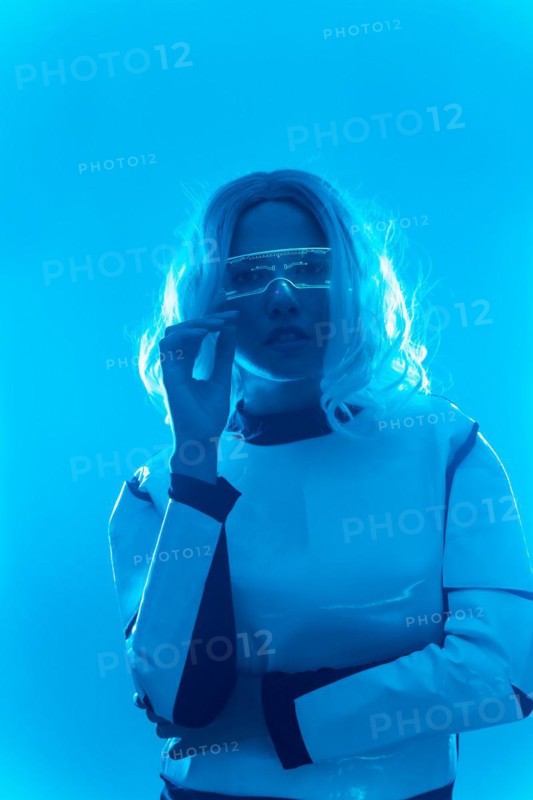 Young woman with futuristic suit and glasses with blue led lights