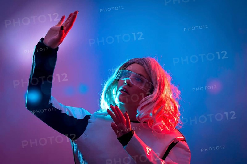 Beautiful woman looking through the futuristic glasses