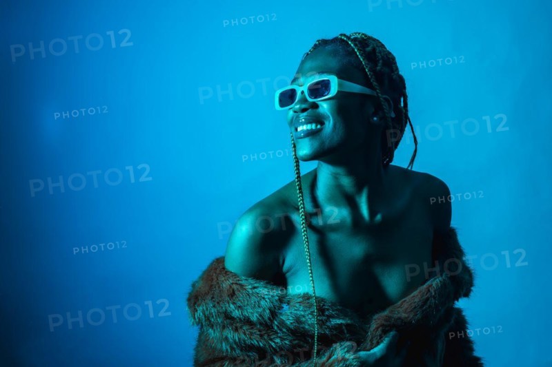 Attractive black ethnic woman with braids with blue led lights