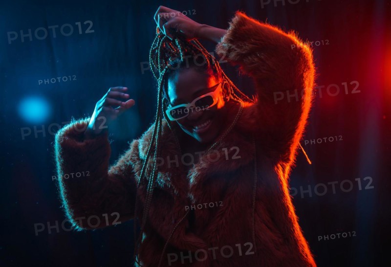Young African woman with braids with blue and red led lights