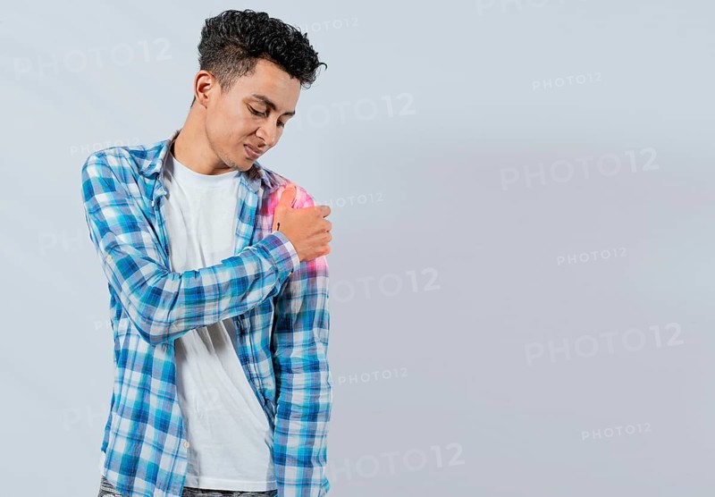 Young man with shoulder pain on white background. Shoulder and arm pain concept. People with shoulder pain on white background. Man suffering with shoulder muscle pain