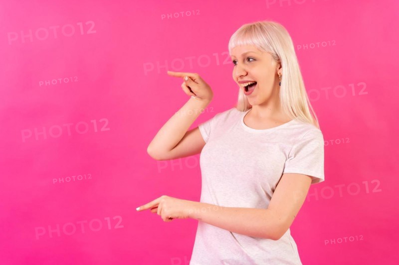 Blonde caucasian girl on pink background studio