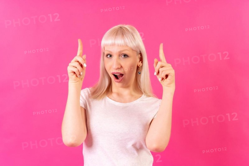Blonde caucasian girl studio shot on pink background