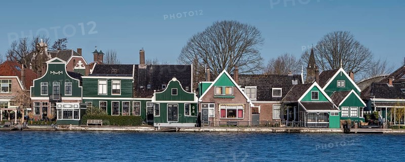 Panoramic photo of a typical colourful country house in Zaandijk on the river Zaan