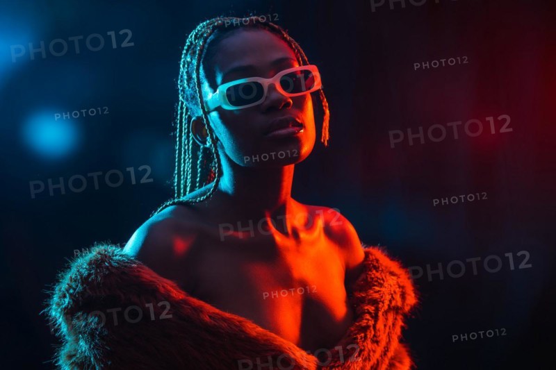 Black ethnic woman with braids with blue and red led lights
