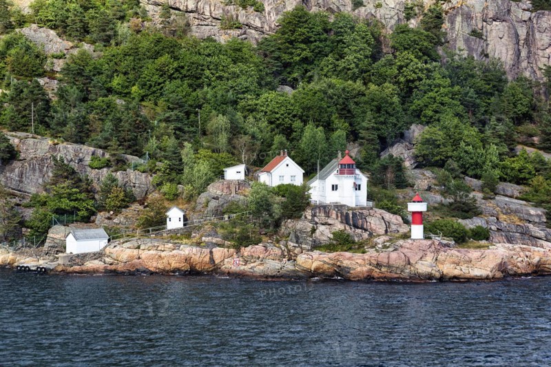 Listed red and white lighthouse on the cliffs of the Odderoya peninsula