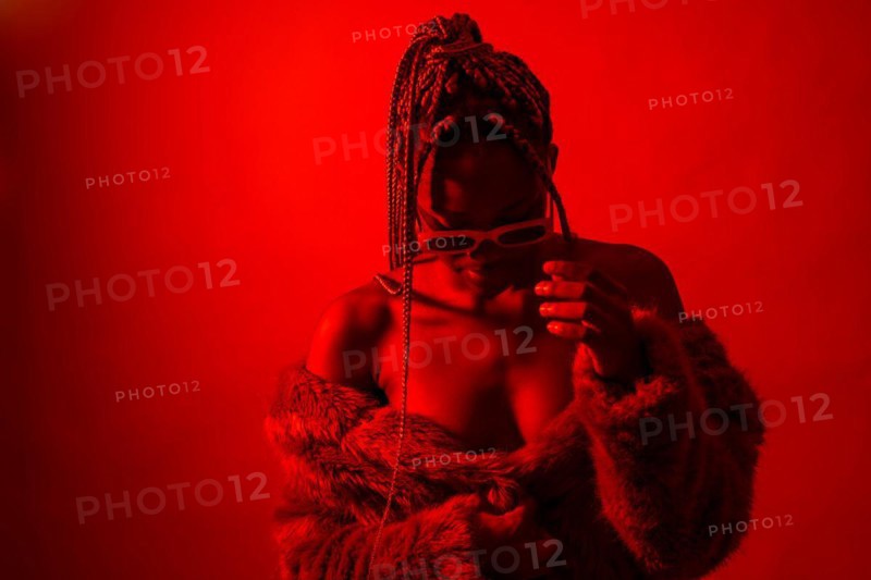 Attractive black ethnic woman with braids with red led lights